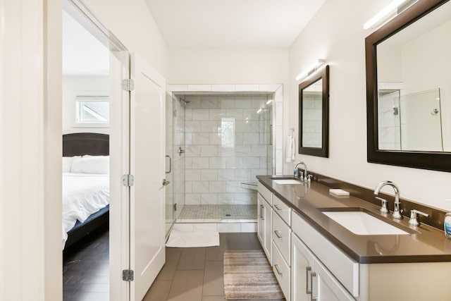 ensuite bathroom featuring double vanity, a sink, ensuite bathroom, and a stall shower