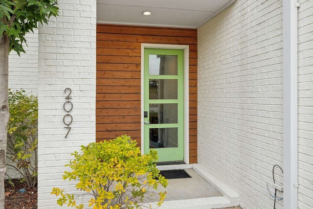 property entrance with brick siding