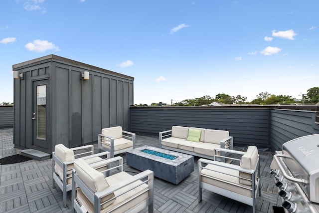 wooden terrace with an outdoor living space with a fire pit and a grill