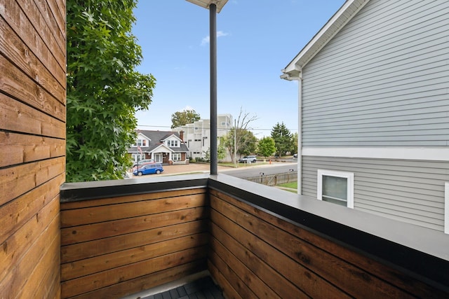 view of home's exterior featuring a balcony and a residential view