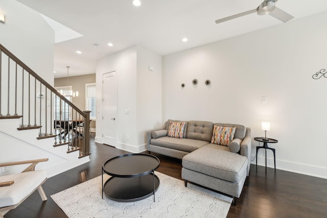 living room featuring wood finished floors, baseboards, stairway, recessed lighting, and ceiling fan with notable chandelier