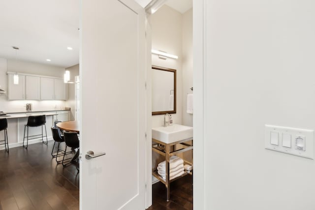 bathroom featuring a sink, recessed lighting, and wood finished floors