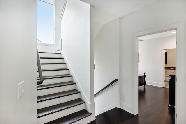stairway featuring baseboards and wood finished floors