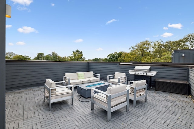 view of patio / terrace featuring an outdoor living space with a fire pit and a grill