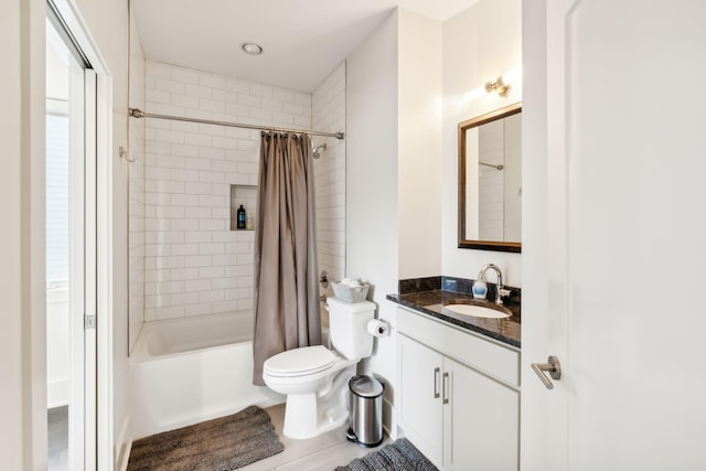 full bathroom with vanity, shower / bathtub combination with curtain, and toilet