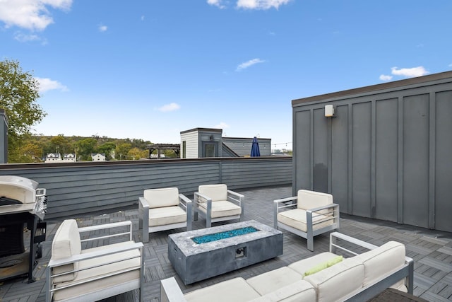 view of patio / terrace with area for grilling and an outdoor living space with a fire pit