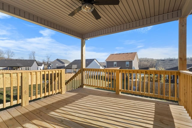 wooden terrace with ceiling fan and a residential view