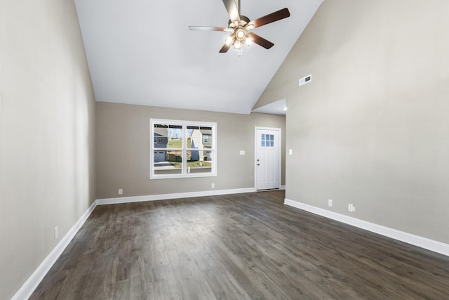 unfurnished living room featuring a ceiling fan, visible vents, dark wood finished floors, baseboards, and high vaulted ceiling