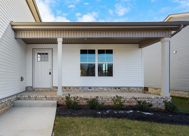view of exterior entry with covered porch