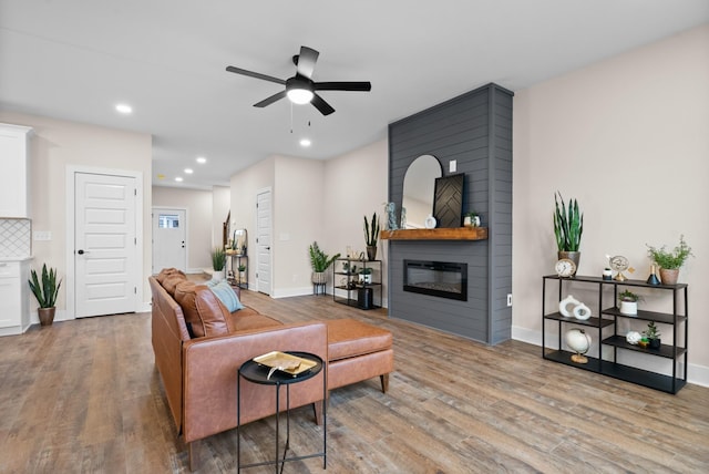 538 Judah Cir, Clarksville, TN 37042 - living area featuring baseboards, a ceiling fan, wood finished floors, and a large fireplace
