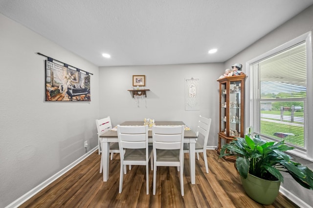 dining room with baseboards, a textured ceiling, recessed lighting, and wood finished floors