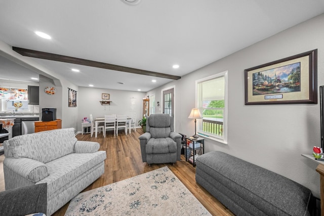 living room featuring recessed lighting, beam ceiling, and wood finished floors