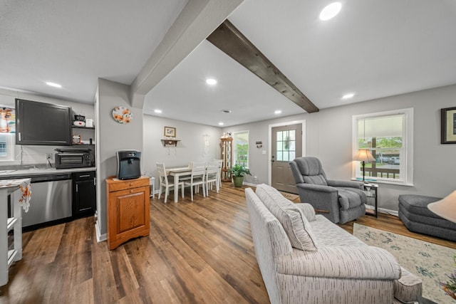 living room with recessed lighting, wood finished floors, and beamed ceiling