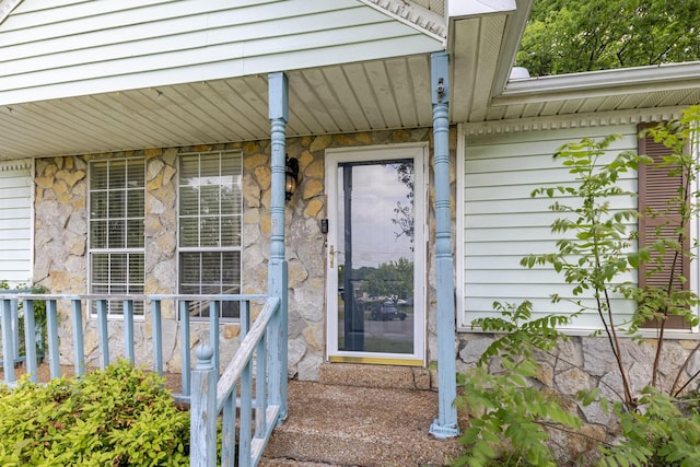 view of exterior entry featuring a porch