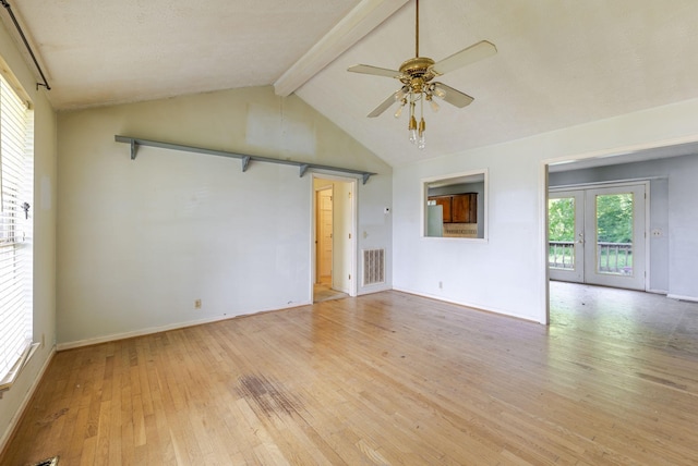 spare room featuring lofted ceiling with beams, light wood-style flooring, a ceiling fan, baseboards, and visible vents