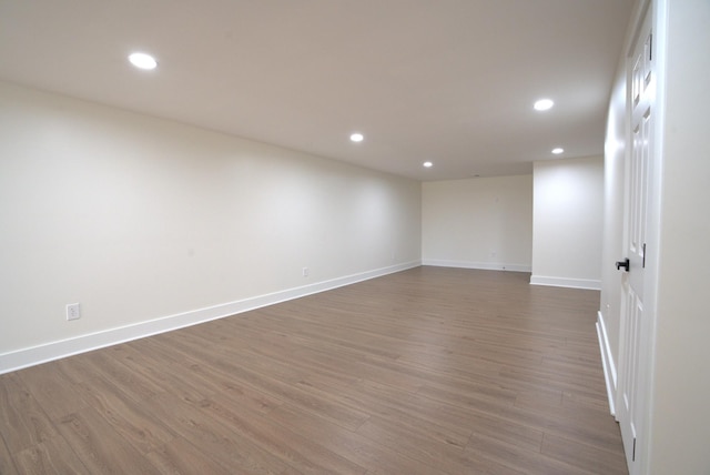 unfurnished room with recessed lighting, baseboards, and wood finished floors