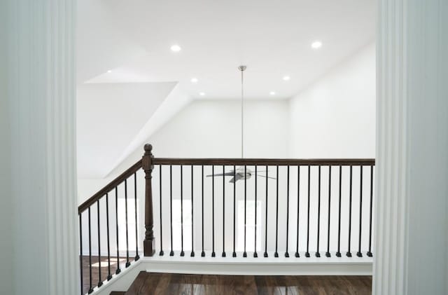 stairway with recessed lighting and wood finished floors