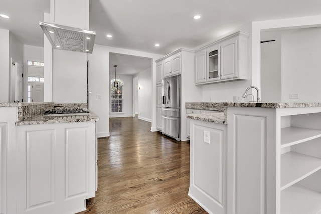 kitchen with white cabinetry, appliances with stainless steel finishes, dark wood-style floors, and light stone counters