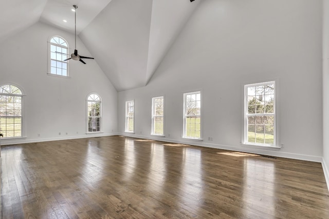 unfurnished living room featuring wood-type flooring, high vaulted ceiling, baseboards, and ceiling fan