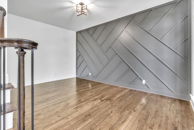 interior space featuring a decorative wall and wood finished floors