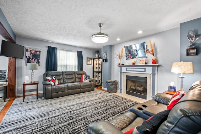 2764 Ann Dr, Clarksville, TN 37040 - living room with wood finished floors, baseboards, recessed lighting, a textured ceiling, and a tile fireplace