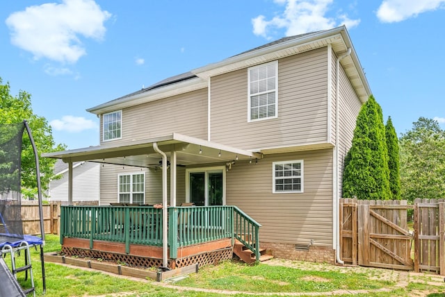 2764 Ann Dr, Clarksville, TN 37040 - rear view of house featuring fence, a deck, a gate, a trampoline, and a yard
