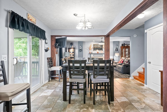 2764 Ann Dr, Clarksville, TN 37040 - dining room with stone finish floor, a textured ceiling, and a chandelier