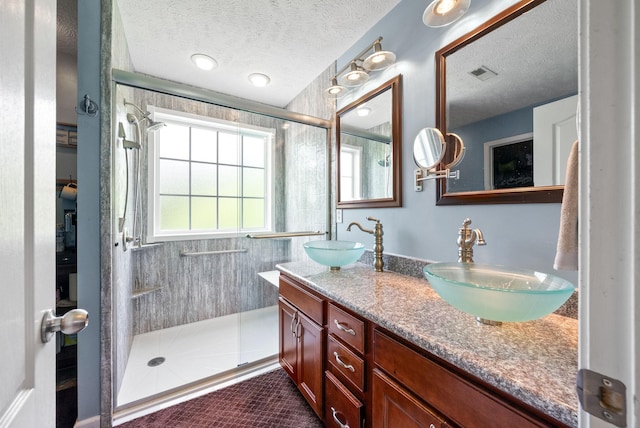 2764 Ann Dr, Clarksville, TN 37040 - full bathroom featuring a sink, a tile shower, a textured ceiling, and visible vents