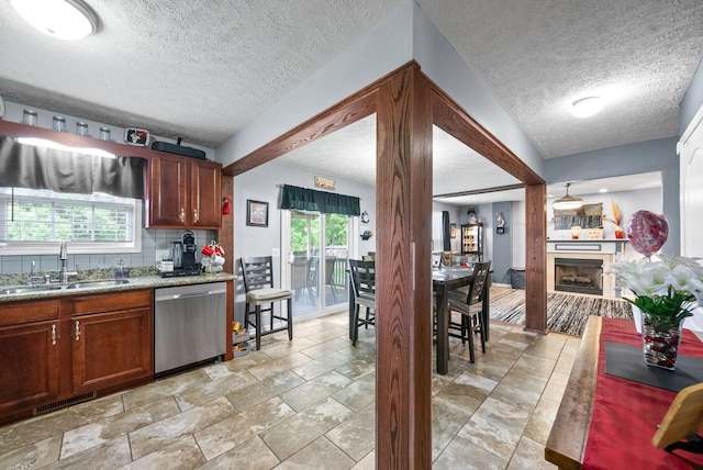 2764 Ann Dr, Clarksville, TN 37040 - kitchen featuring a sink, dishwasher, a textured ceiling, backsplash, and visible vents