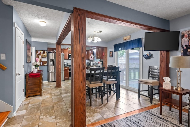 2764 Ann Dr, Clarksville, TN 37040 - dining area featuring a textured ceiling and a chandelier
