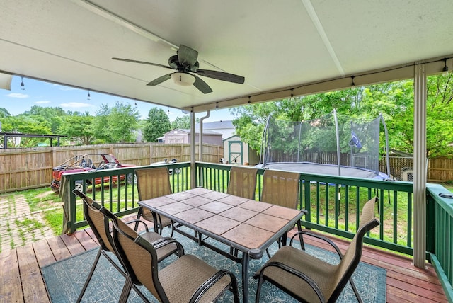 2764 Ann Dr, Clarksville, TN 37040 - wooden deck featuring a fenced backyard, outdoor dining space, a trampoline, and a shed