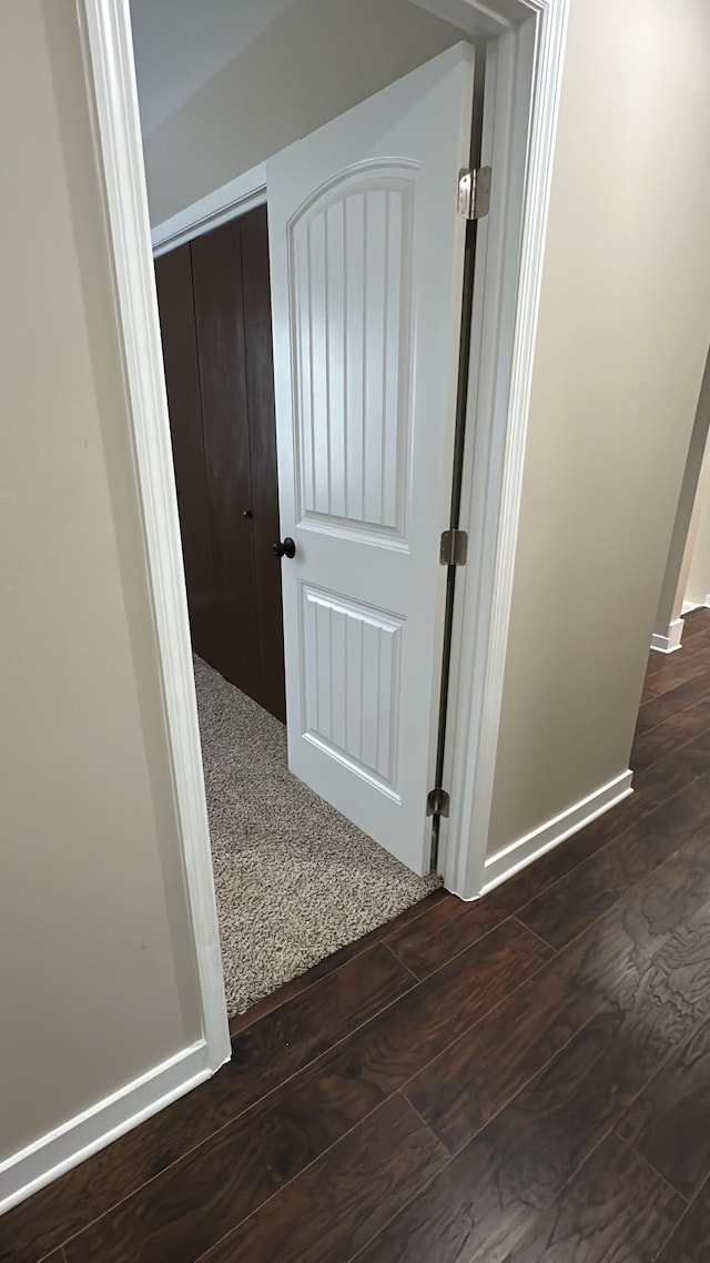 hall with dark wood-type flooring