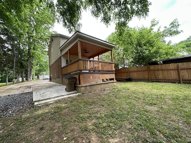 back of property featuring ceiling fan, fence, and a wooden deck