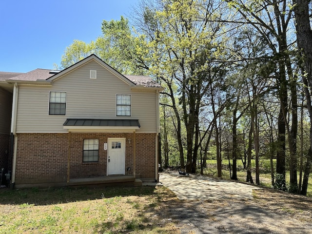 view of front of house featuring brick siding and driveway