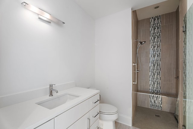 full bath featuring vanity, toilet, and a stall shower