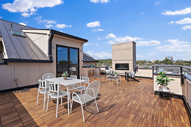 wooden terrace featuring outdoor dining area