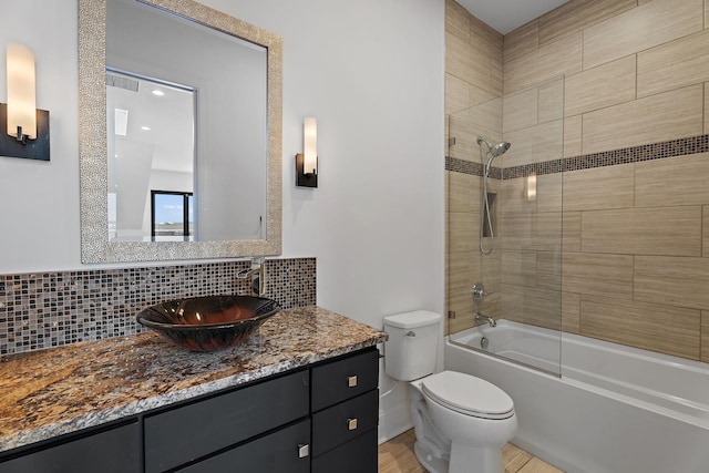 full bathroom featuring vanity, decorative backsplash, toilet, and shower / washtub combination