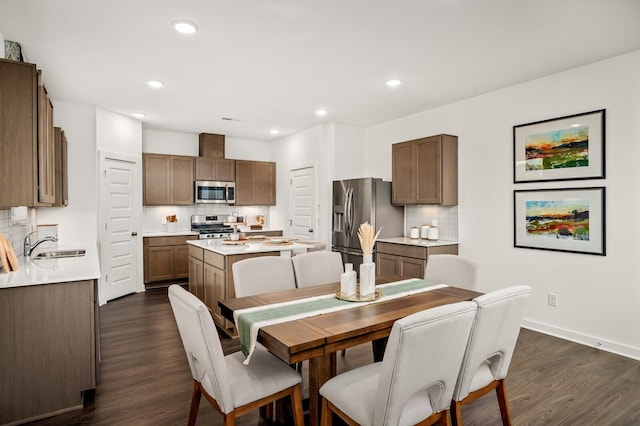 dining space with recessed lighting, baseboards, and dark wood-type flooring
