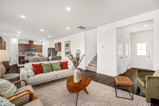living area with stairs, recessed lighting, visible vents, and dark wood finished floors