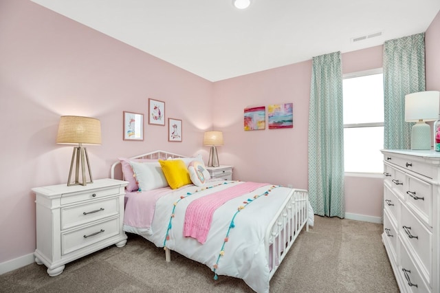 bedroom with baseboards, light carpet, and visible vents
