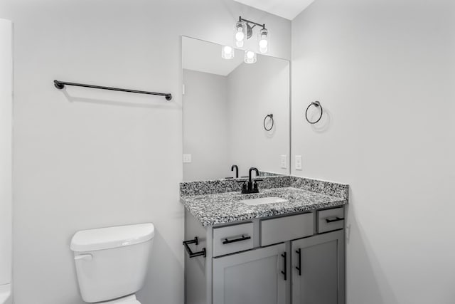 bathroom featuring toilet and vanity