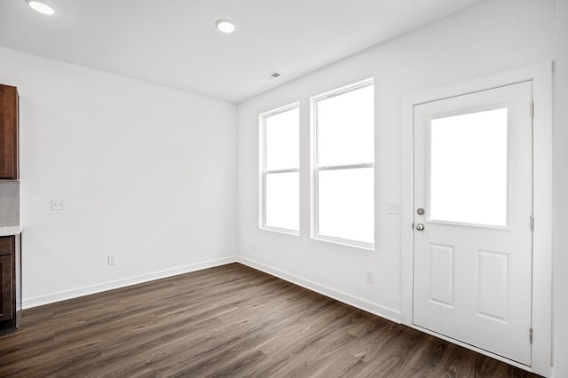 interior space featuring baseboards, recessed lighting, dark wood-style floors, and visible vents