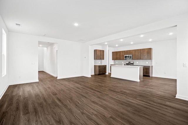 unfurnished living room with baseboards, recessed lighting, dark wood-style floors, and visible vents