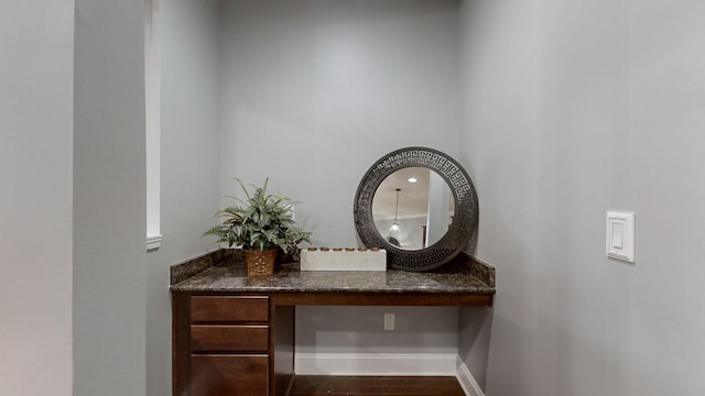 room details featuring baseboards and wood finished floors