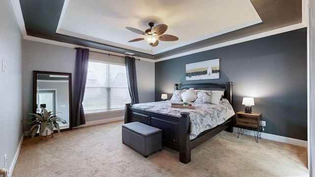 bedroom featuring light carpet, crown molding, a raised ceiling, and baseboards