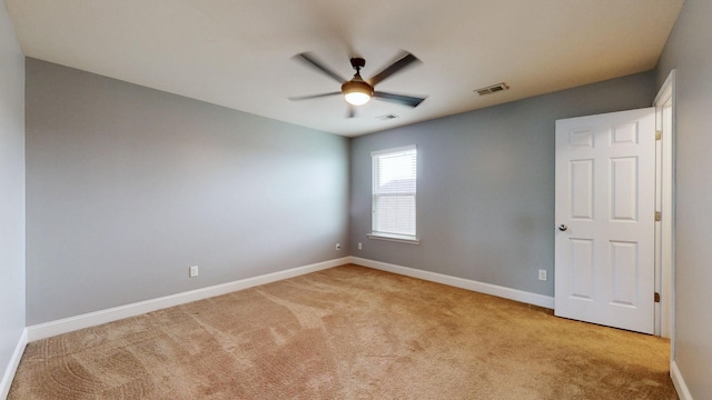 empty room featuring visible vents, baseboards, ceiling fan, and light colored carpet