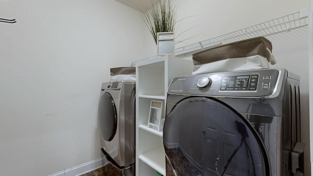 laundry room with separate washer and dryer, baseboards, and laundry area