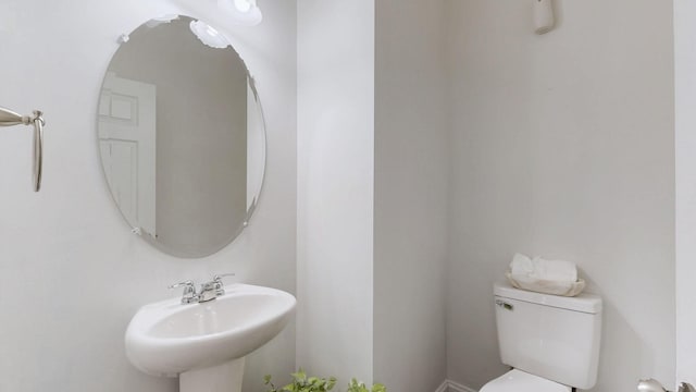 half bath with toilet and a sink