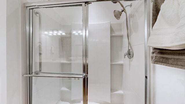 full bath featuring a shower stall