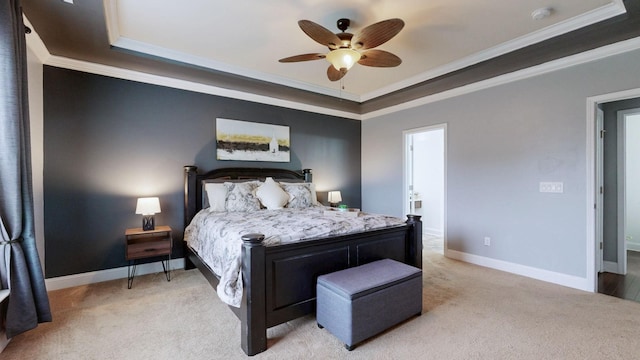bedroom with crown molding, ceiling fan, light colored carpet, a raised ceiling, and baseboards
